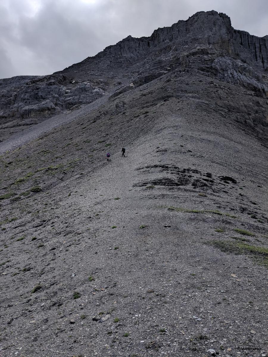 hikers scrambling up Roche Miette