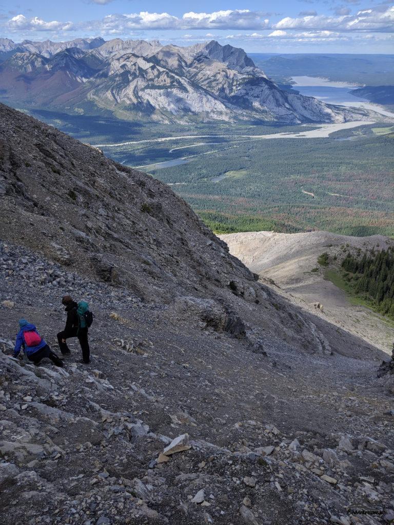 hikers navigating the steep descent from the mountain