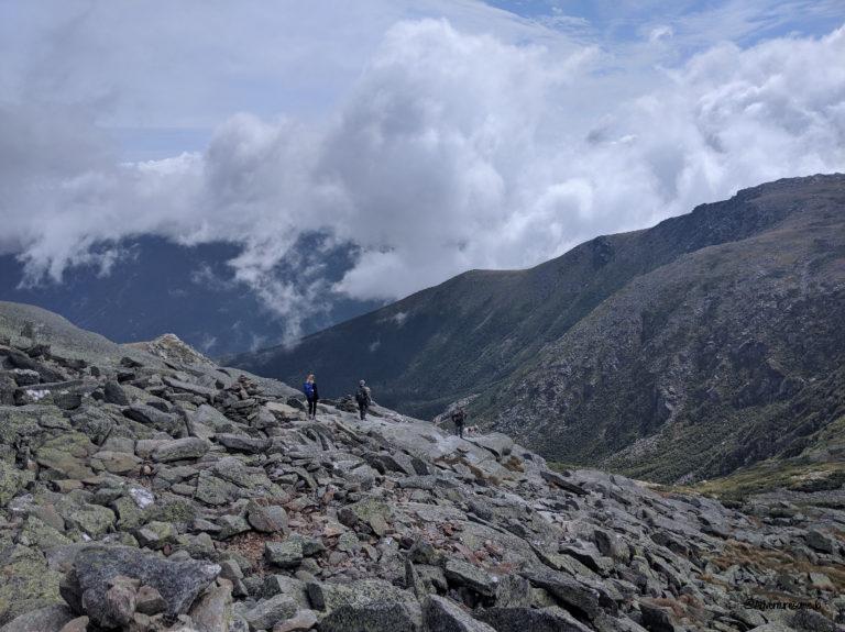 hikers scrambling the rocky trail of Mount Washington