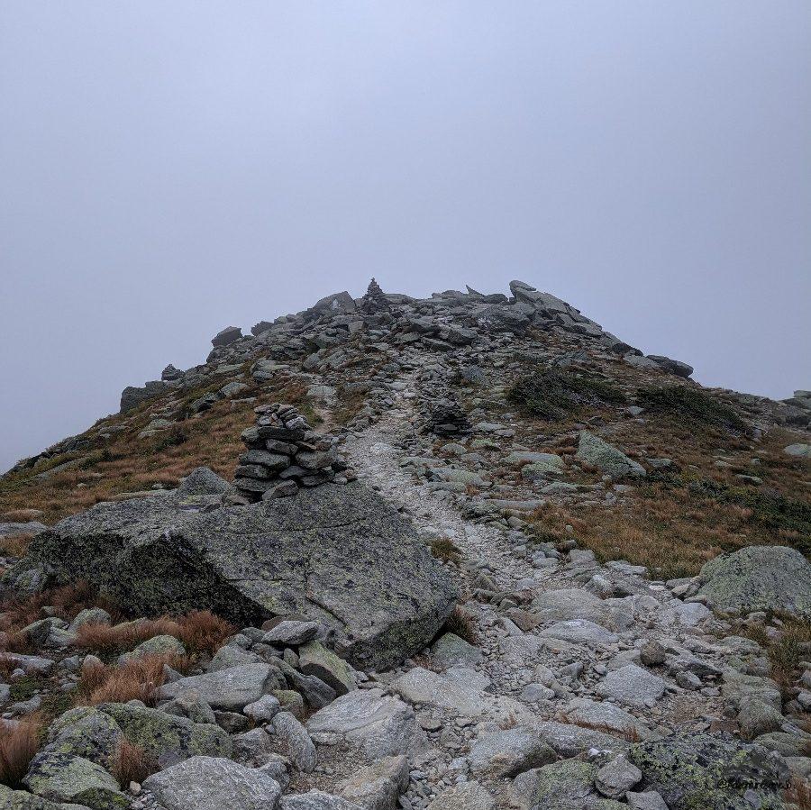 Tuckerman Ravine Trail marked by cairns with tundra all around on Mount Washington