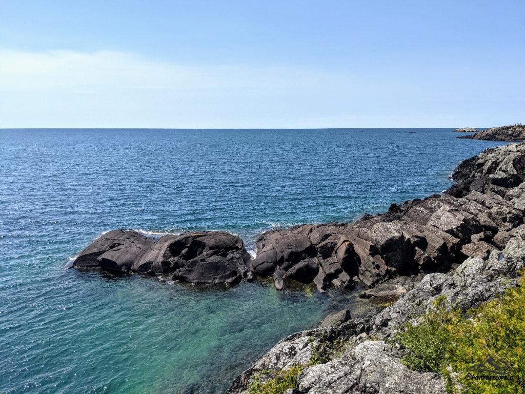 the rocky shore and blue waters of Lake Superior