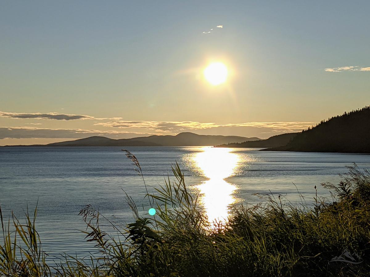 Sun setting over the hills on the far side of the shore of Lake Superior in Marathon, Northern Ontario