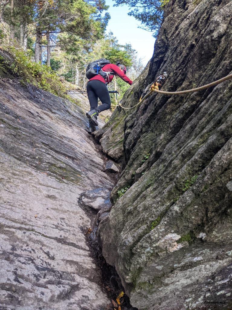 Ropes to help hiker up the steep rock on Round Top Trail
