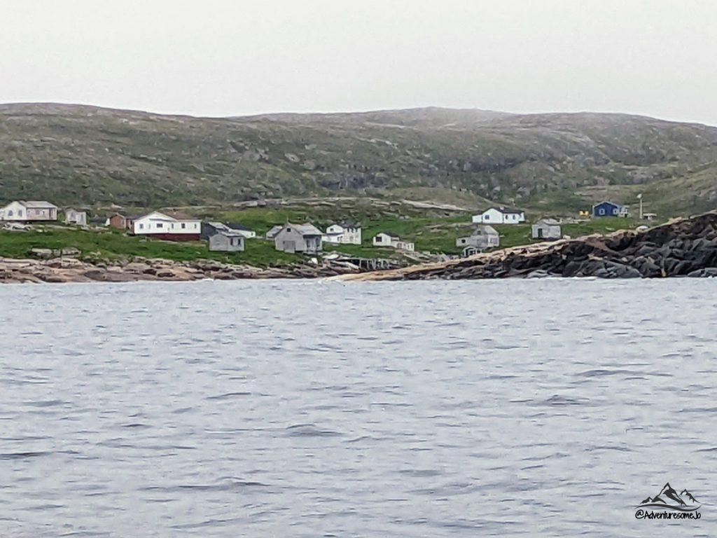 Battle Harbour as seen from the boat with scattered fishermen's houses and the hills in the background