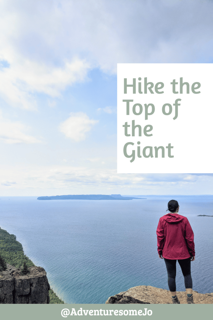 hiker standing on the Giant's knees looking out at Lake Superior in the pin for the hike in Sleeping Giant Provincial Park