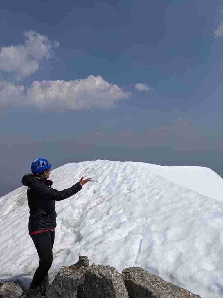 playing in the snow on Mount Temple's summit