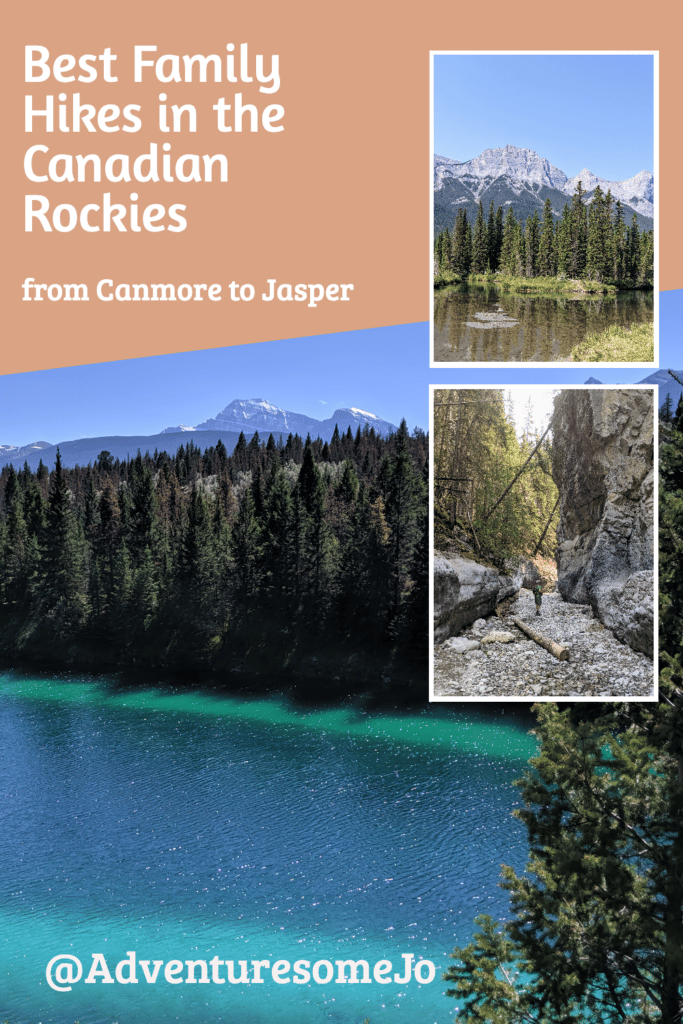 blue lake surrounded by conifers, hiker on a rocky trail in a canyon and mountains in the distance behind a creek
