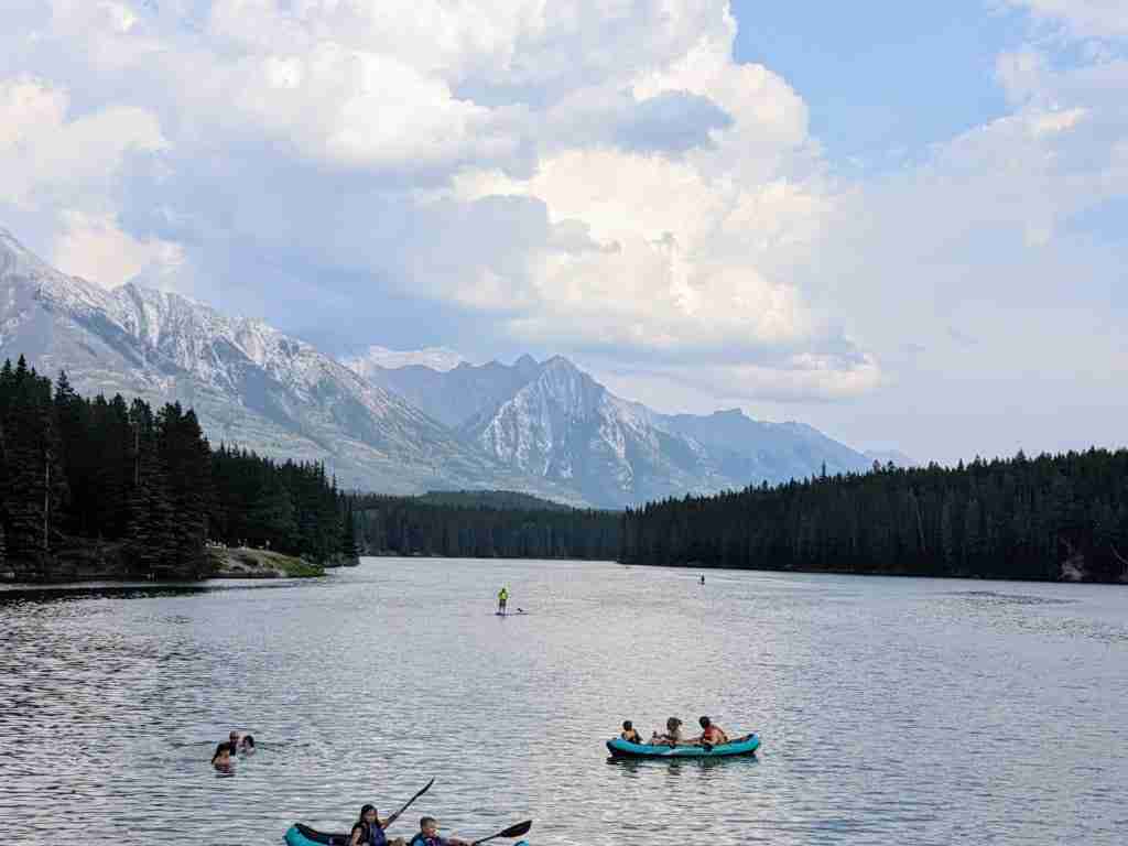 Tourists enjoying a swim and a paddle in Johnson Lake in Banff