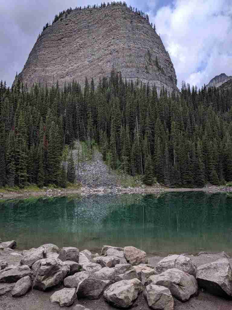 Big Beehive reflecting in the green water of Mirror Lake