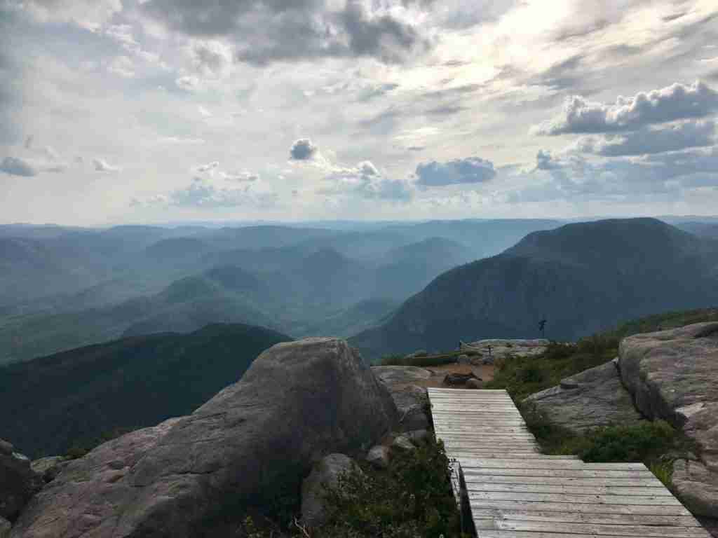 boardwalk on the summit of mont du lac des Cygnes with the view of the green hills
