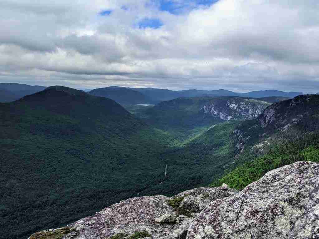 view of the green valley and hills from the summit of Mont des Morios