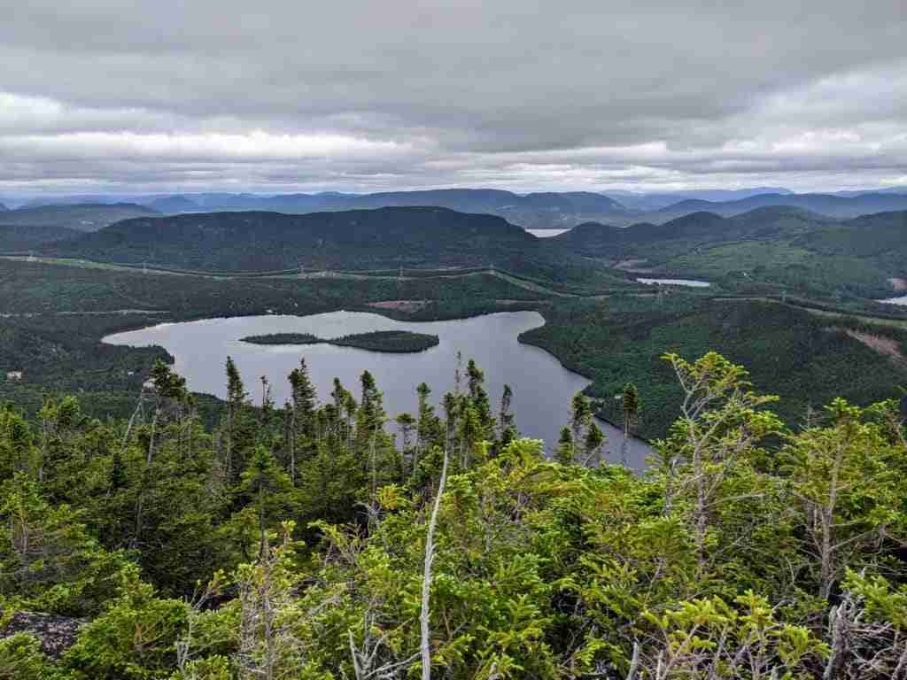 view of the lake and green hills from mont Menaud summit