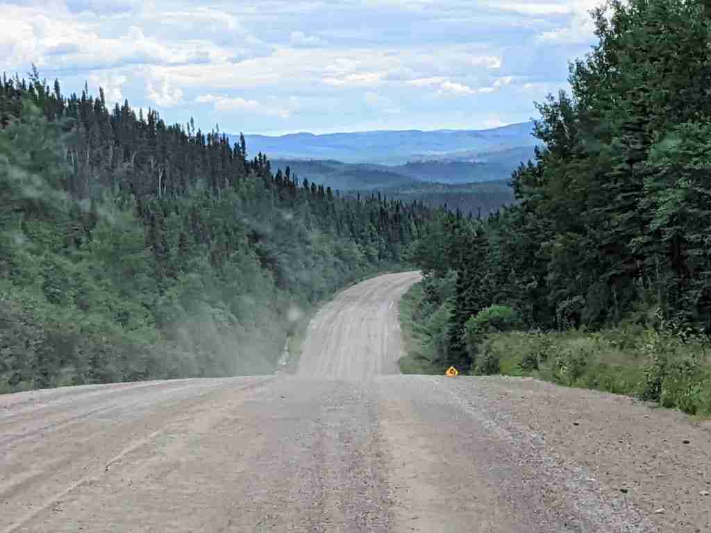 Gravel part of Route 389 with roling hills near Fermont, Quebec