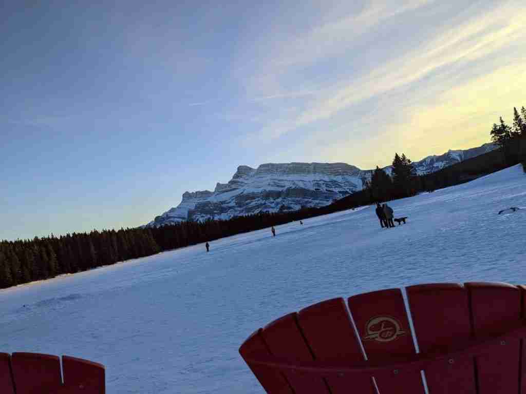 red chairs on Two Jack Lake in winter in Banff