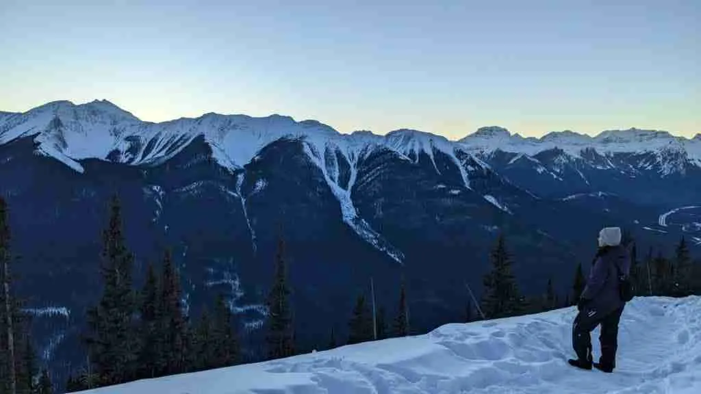view of the snowy mountain range from Sulphur on the Banff Gondola Nightrise in winter