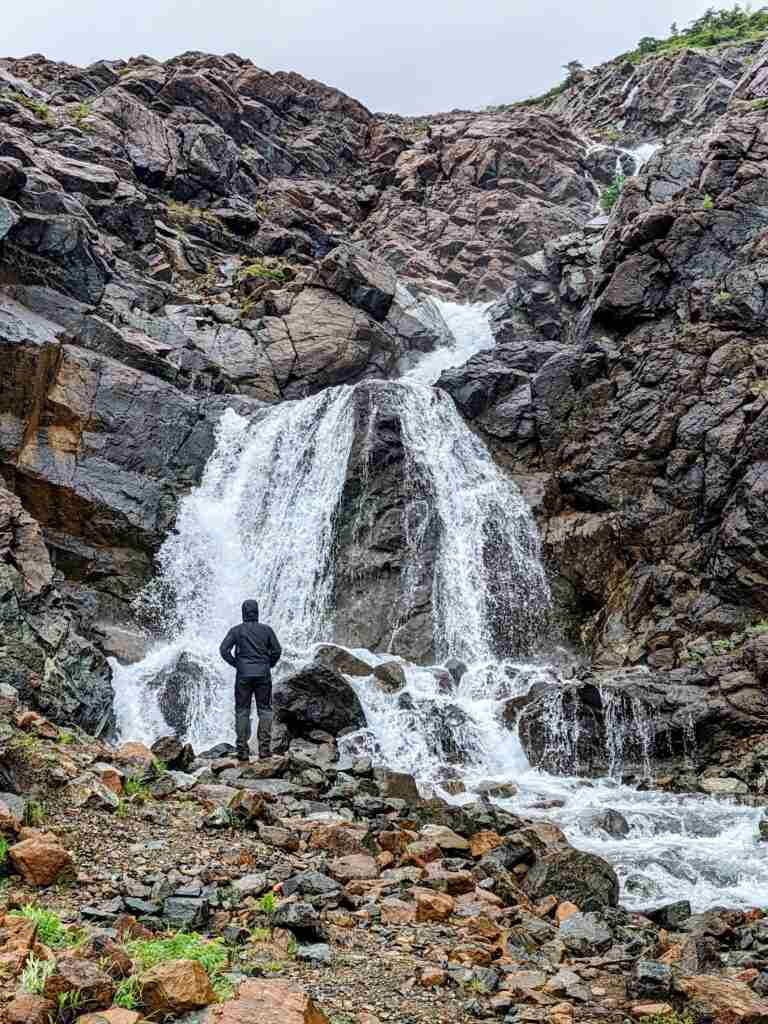 Standing at the foot of the waterfall hiking Tablelands Trail