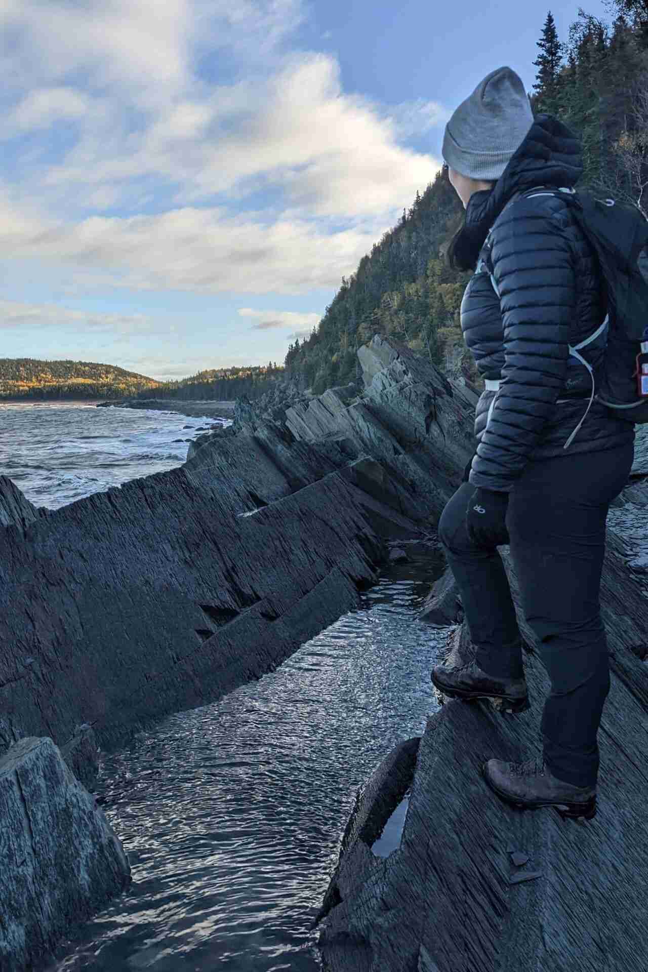 Standing on the rocky Le Grand Tour Trail parc national du BIc looking over the St. Lawrence River