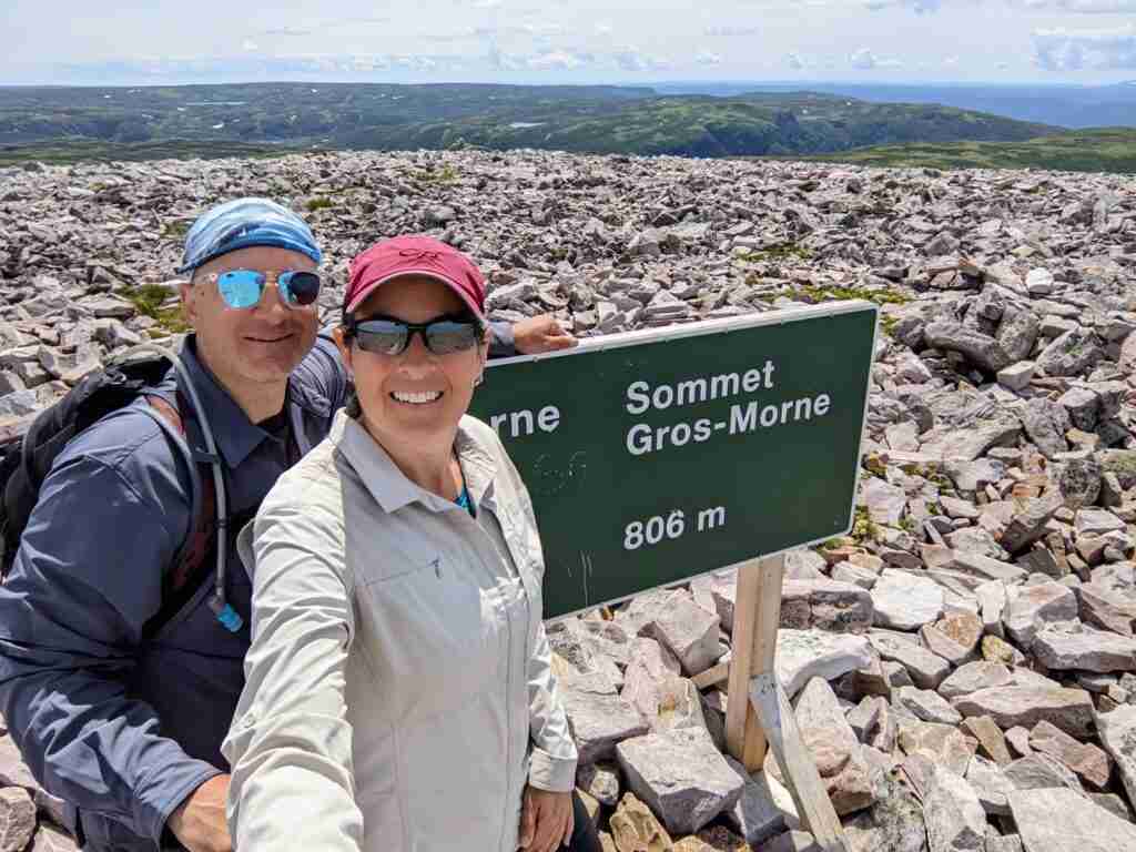 selfie with the usummit sign on Gros Morne Mountain