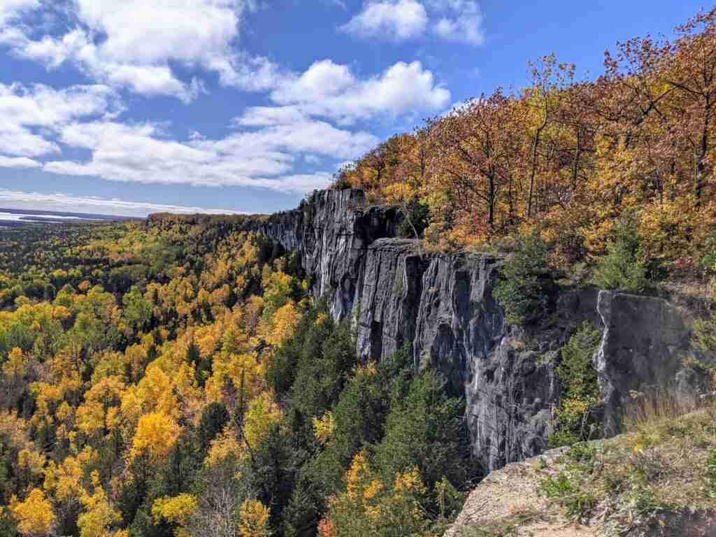 cliffs over a forest with fall colours in full bloom on Manitoulin Island