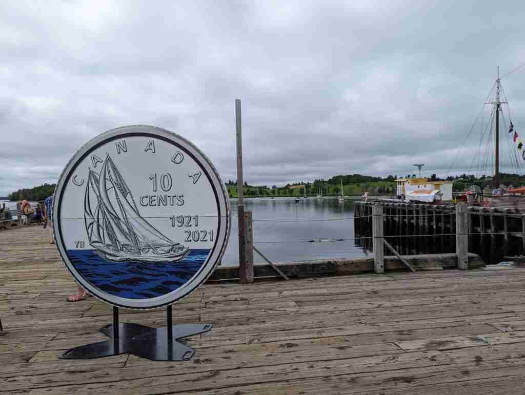 giant dime featuring the Bluenose on the waterfront in Lunenburg where the sailboat is usually docked.