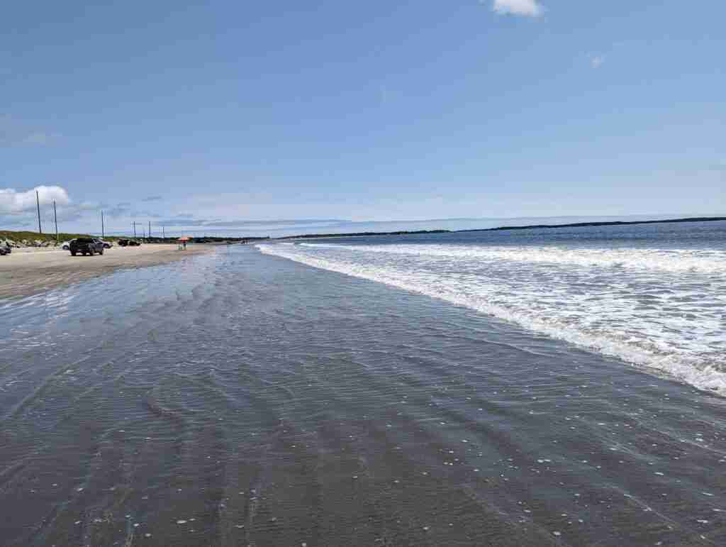 the sand and waves of Crescent Beach in Nova Scotia
