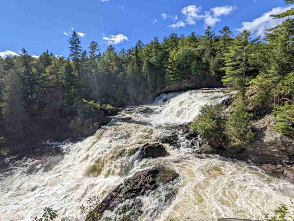 Plaisance Falls boredered by conifers