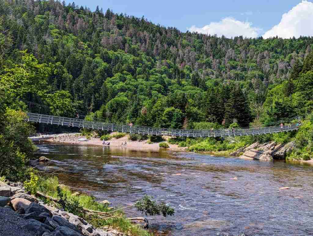 Suspension bridge over the shallow Big Salmon River on the Fundy Trail Parkway