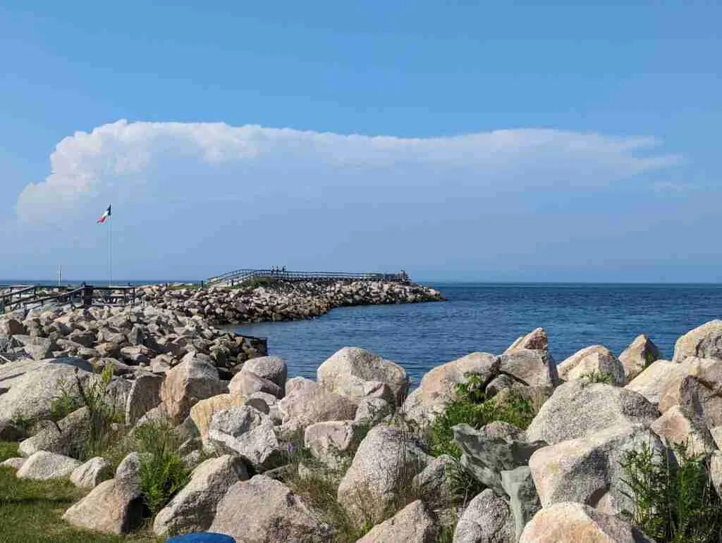 wharf with the Acadian flag floting in the wind