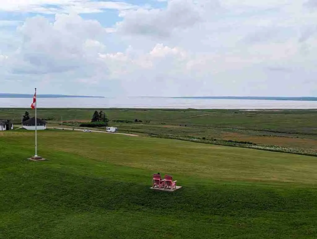 Parks Canada red chairs and the Canadian flag seen from high above on the grounds of the Fort Beauséjour in New Brunswick