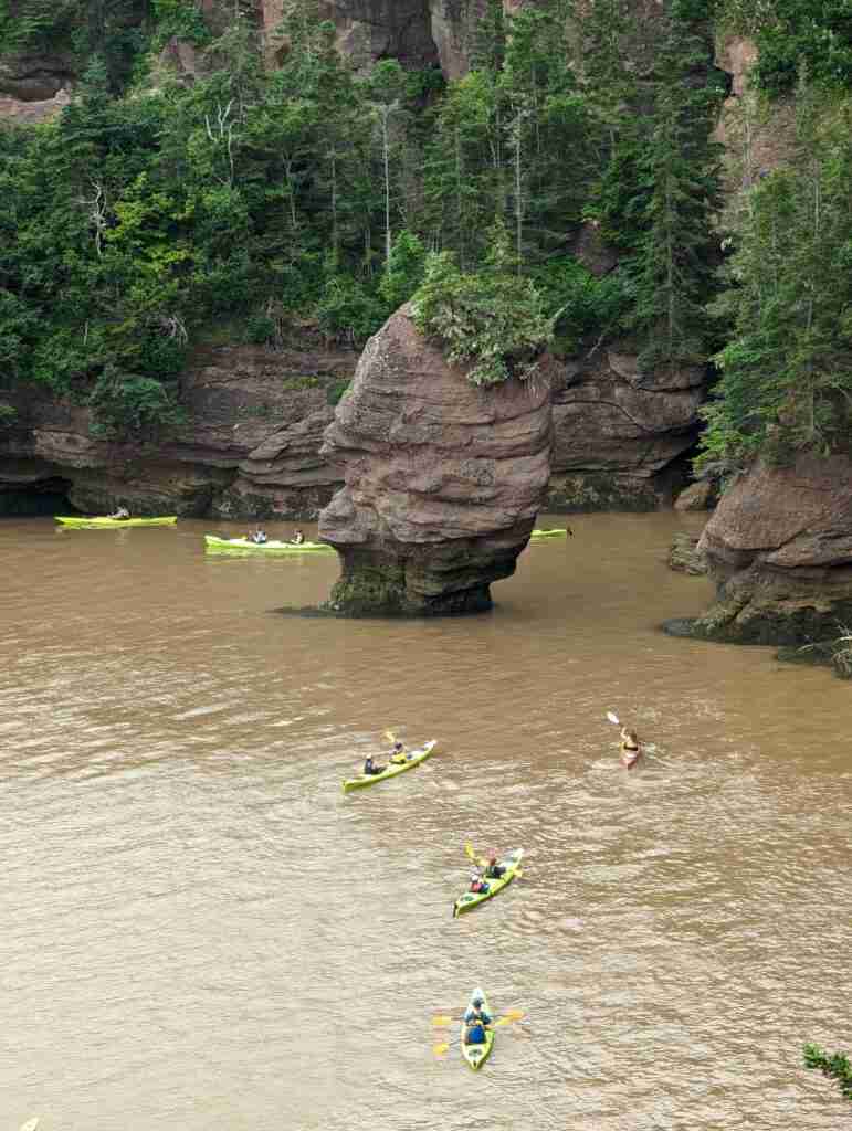 kayakers paddling around Sea stacks at high tide in Hopewell Rocks Provincial Park