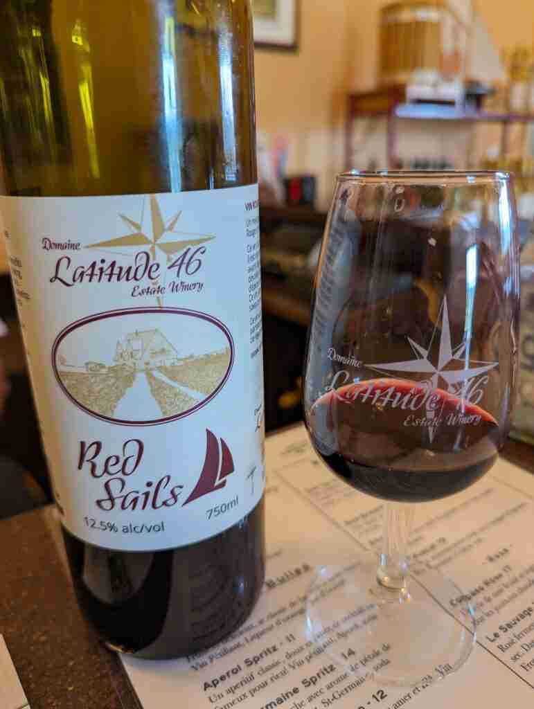 bottle and glass of red wine from the Latitude 46 winery in New Brunswick