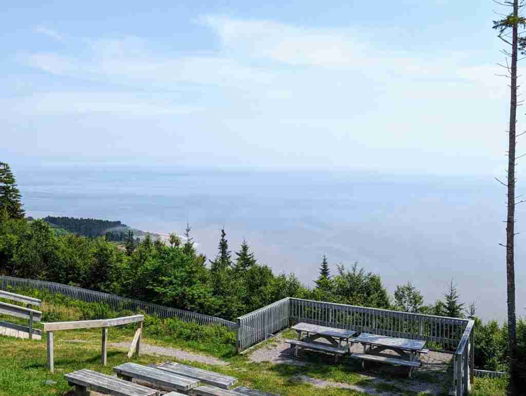 picnic area and railing with a view of the sea