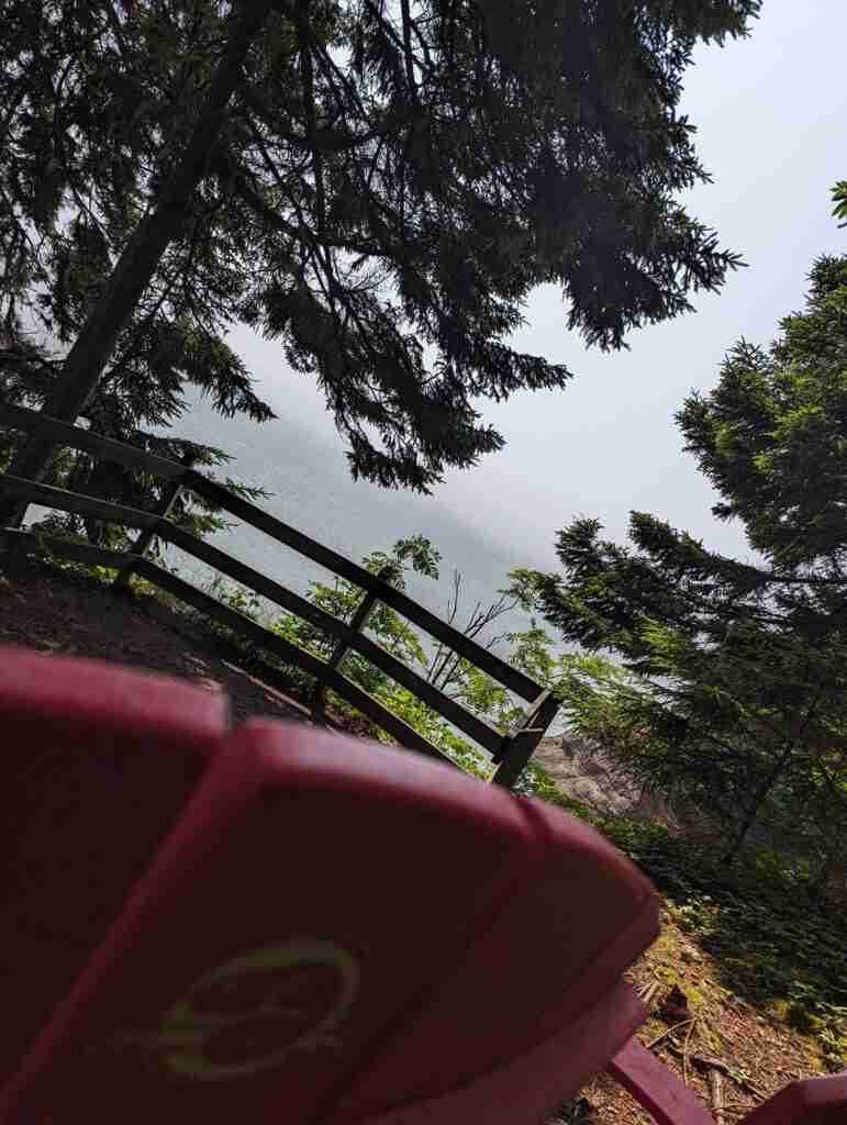 Red Chair with the Parks Canada logo looking out over the Bay of Fundy