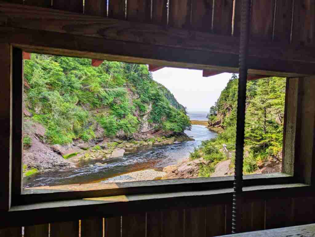 The river and high cliffs on each side viewed from the window of the covered bridge