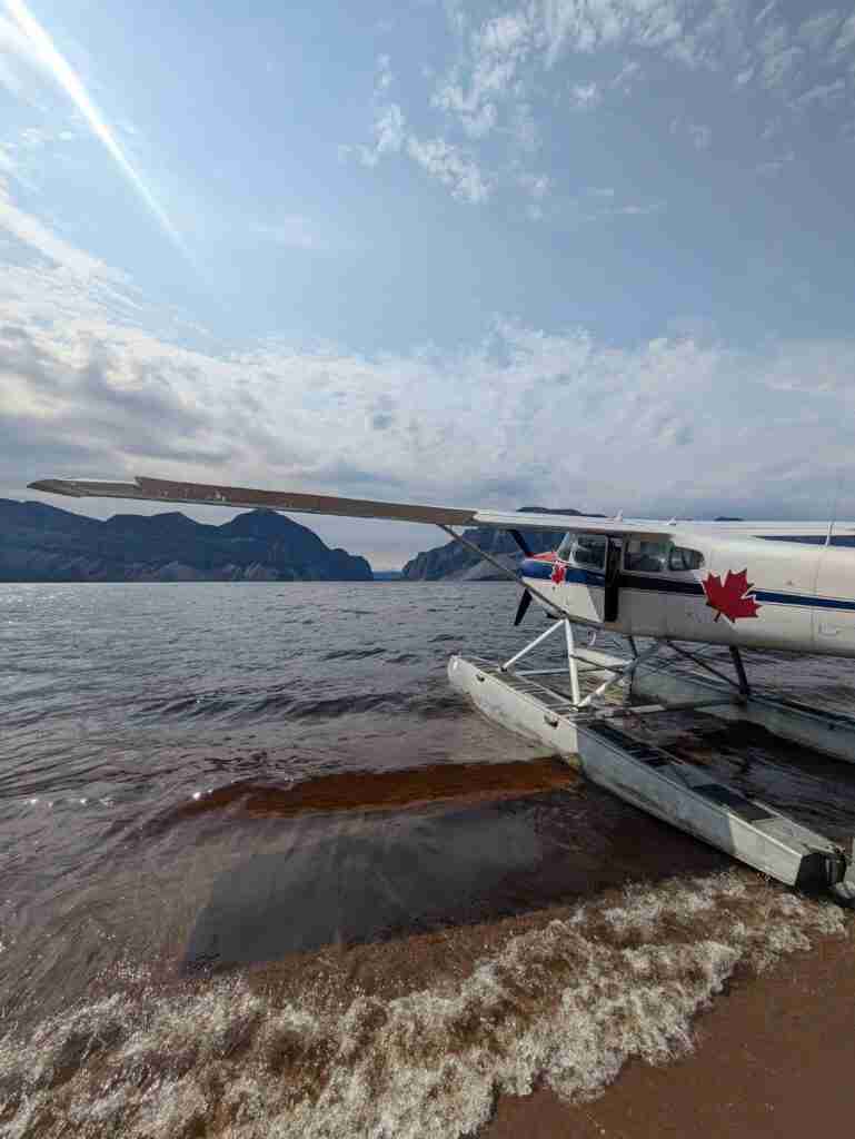Float plane on Doctor Lake with mountains on the far shore in Northwest Territories