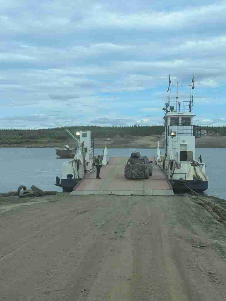 car on a ferry crossing a river in Northwest Territories