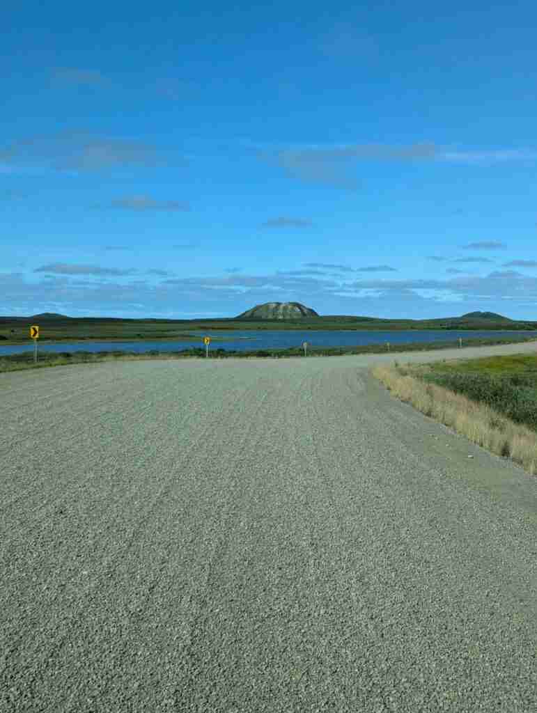 gravel road to Tuktoyaktuk with the pingo in the distance