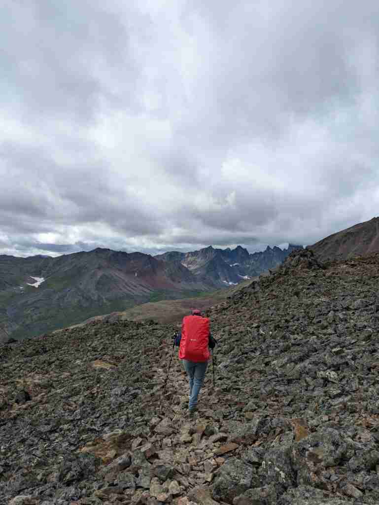 backpacker on the Grizzly Lake Trail with the view of the mountains