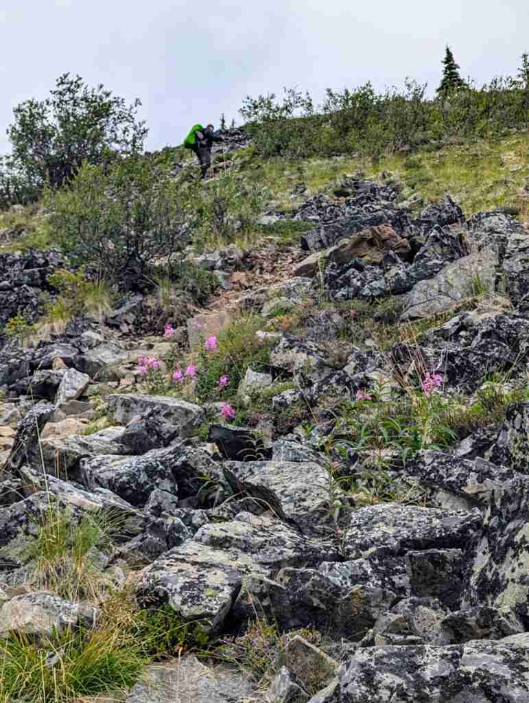 hiker climbing the on boulders on the Grizzly Lake Trail