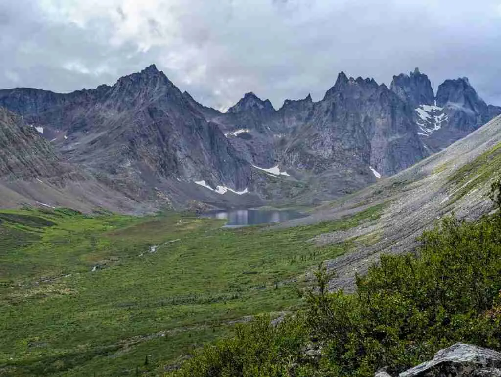 view of Grizzly Lake surrounded by tall jagged mountains