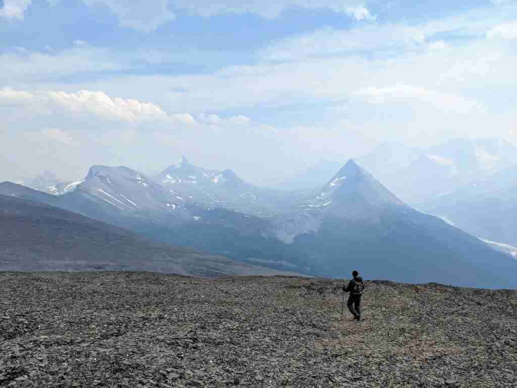 Hiker walking on loose scree in Tangle Ridge